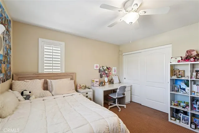 a view of a workspace with furniture and a bookshelf