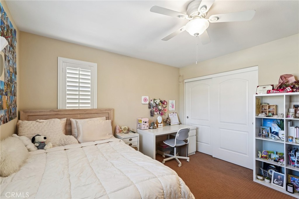 36274 Waxen Road Lake Elsinore, CA 92532 - Photo 23 of 65 a bedroom with a bed and a book shelf