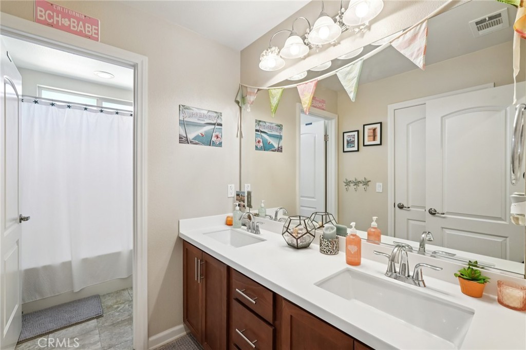 36274 Waxen Road Lake Elsinore, CA 92532 - Photo 24 of 65 a bathroom with a sink vanity granite and a mirror