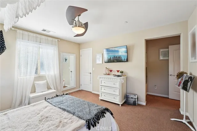 a living room with furniture a flat screen tv and kitchen view