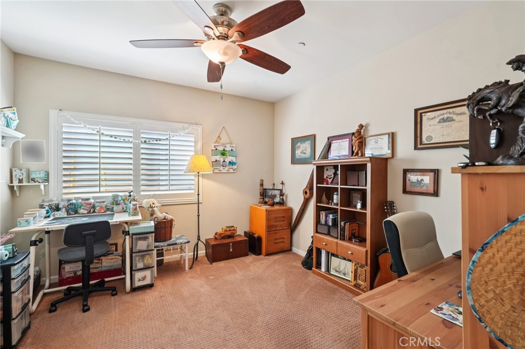 36274 Waxen Road Lake Elsinore, CA 92532 - Photo 27 of 65 a view of a workspace with furniture and a bookshelf