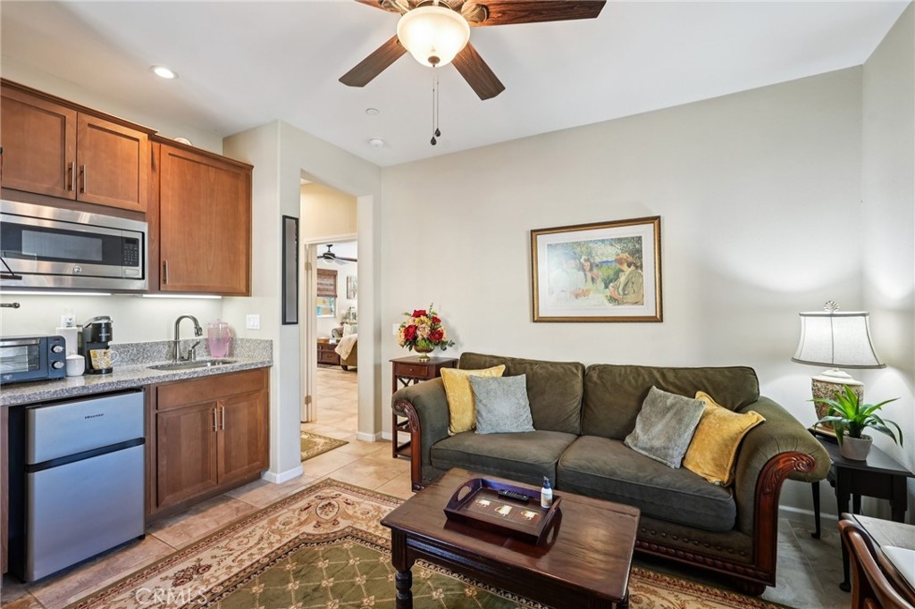 36274 Waxen Road Lake Elsinore, CA 92532 - Photo 30 of 65 a living room with furniture a flat screen tv and kitchen view