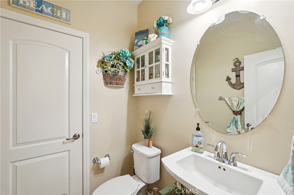 36274 Waxen Road Lake Elsinore, CA 92532 - Photo 34 of 65 a bathroom with a toilet sink and mirror