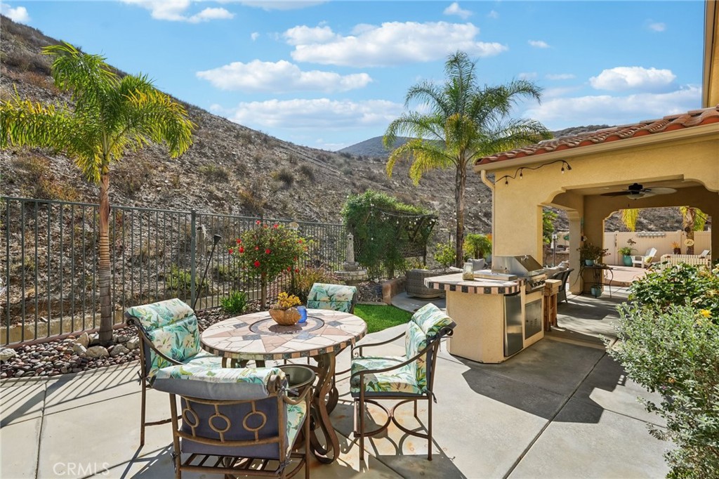36274 Waxen Road Lake Elsinore, CA 92532 - Photo 36 of 65 a view of a patio with table and chairs and potted plants