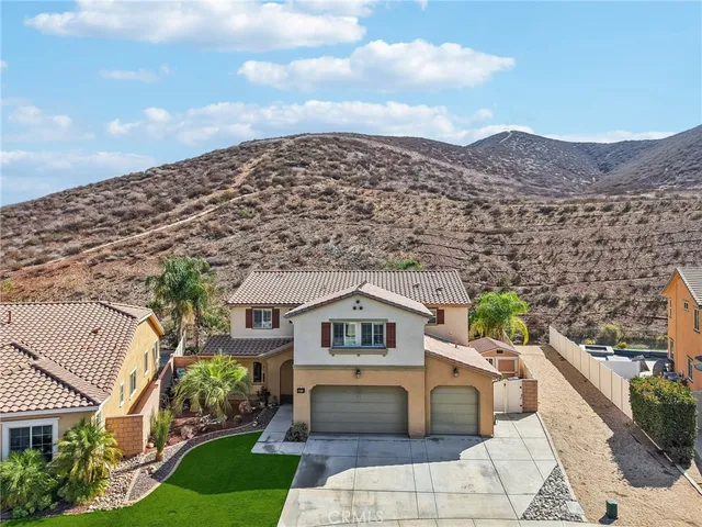 an aerial view of a house with a yard and potted plants