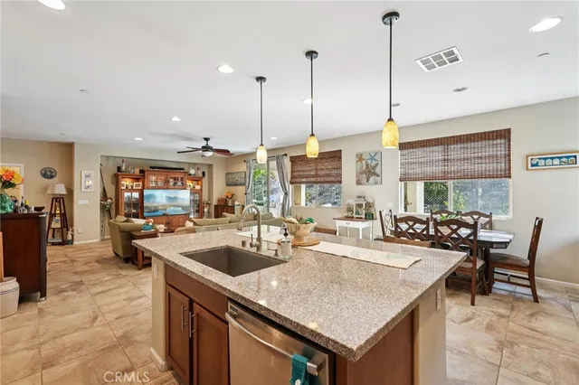 a living room with furniture and a ceiling fan