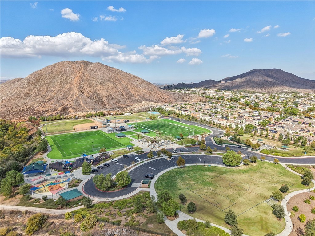 36274 Waxen Road Lake Elsinore, CA 92532 - Photo 62 of 65 a view of a swimming pool with a table and chairs