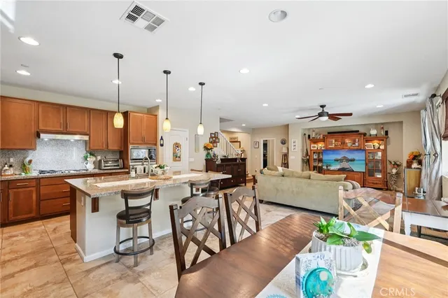 a living room with furniture a flat screen tv and a table