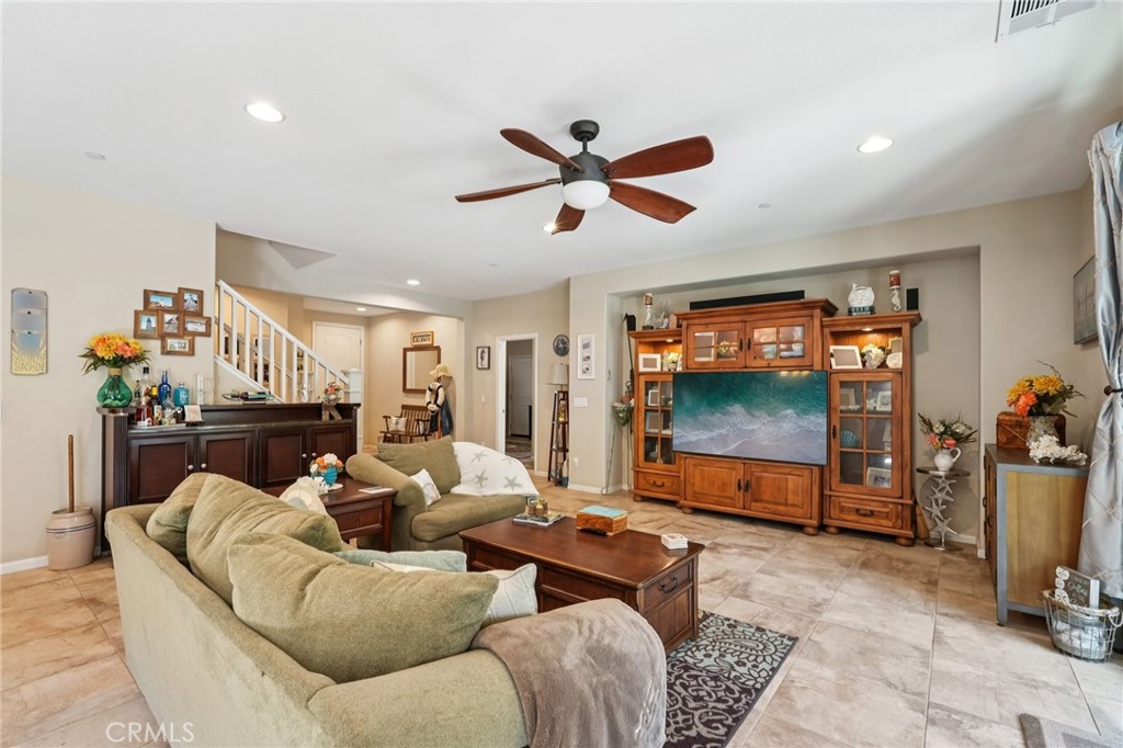 36274 Waxen Road Lake Elsinore, CA 92532 - Photo 10 of 65 a living room with furniture a ceiling fan and a window