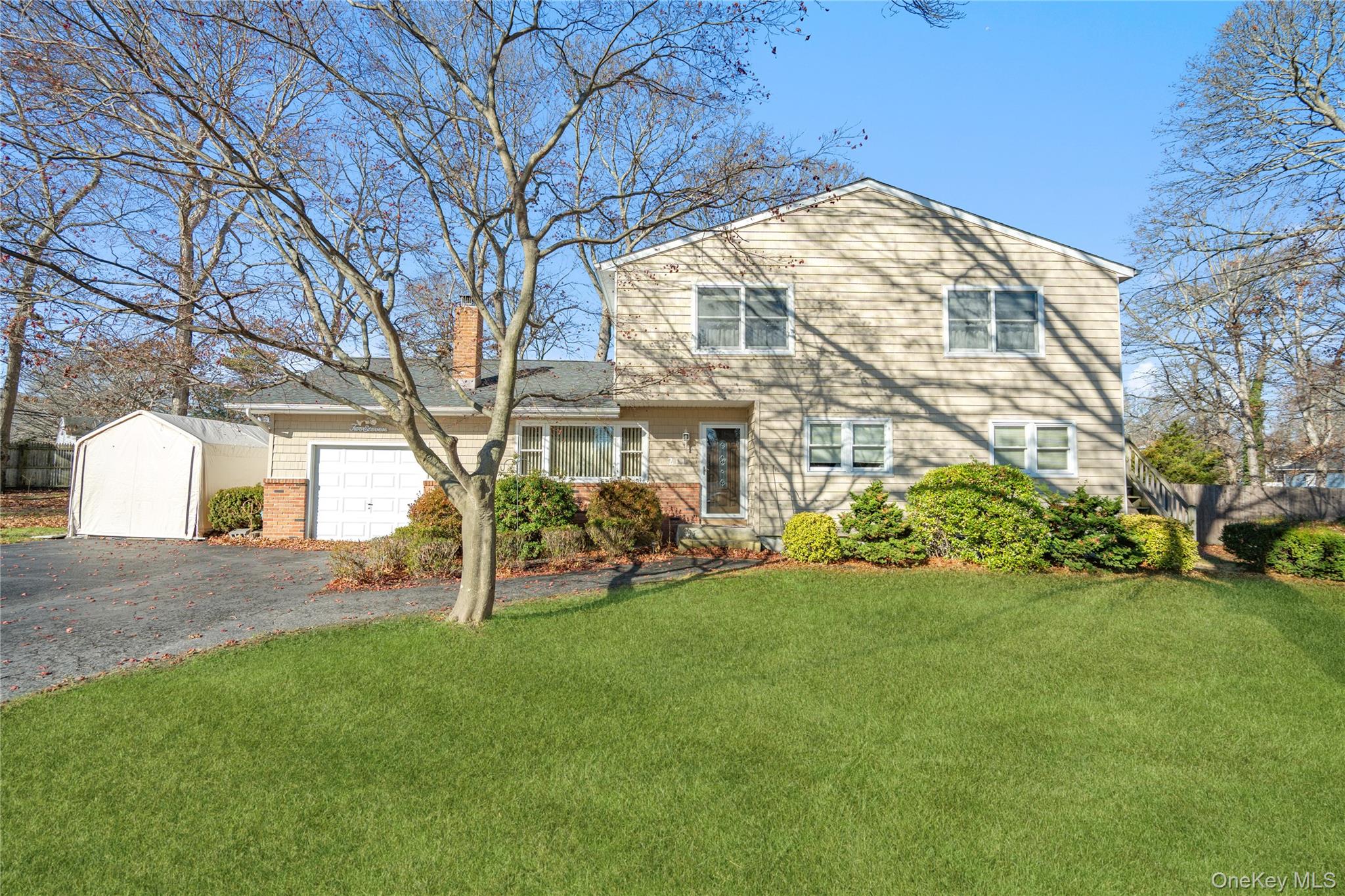 a view of a house with a yard and sitting area