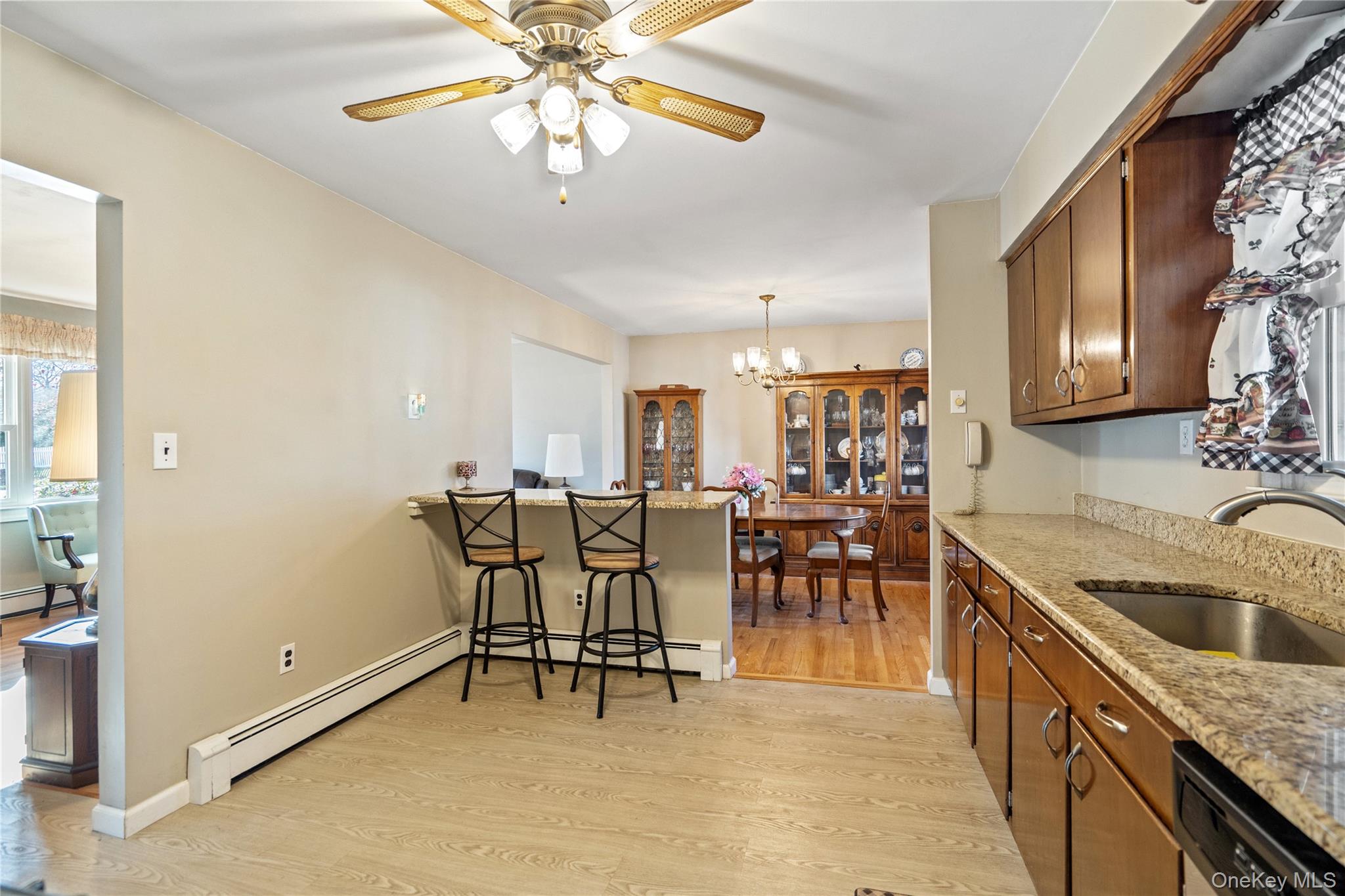 211 Mooney Pond Road Selden, NY 11784 - Photo 13 of 41 a kitchen with a dining table and chairs