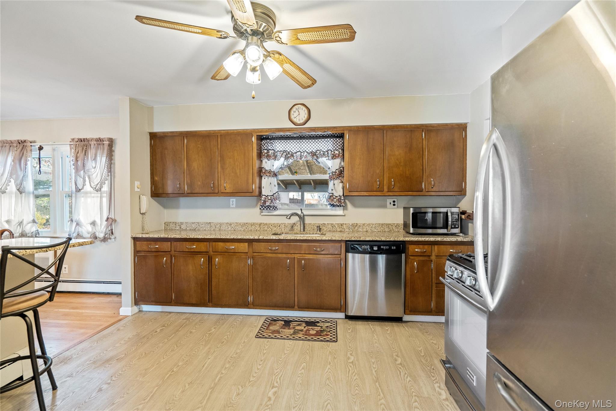 211 Mooney Pond Road Selden, NY 11784 - Photo 14 of 41 a kitchen with stainless steel appliances granite countertop a stove a sink dishwasher and a refrigerator