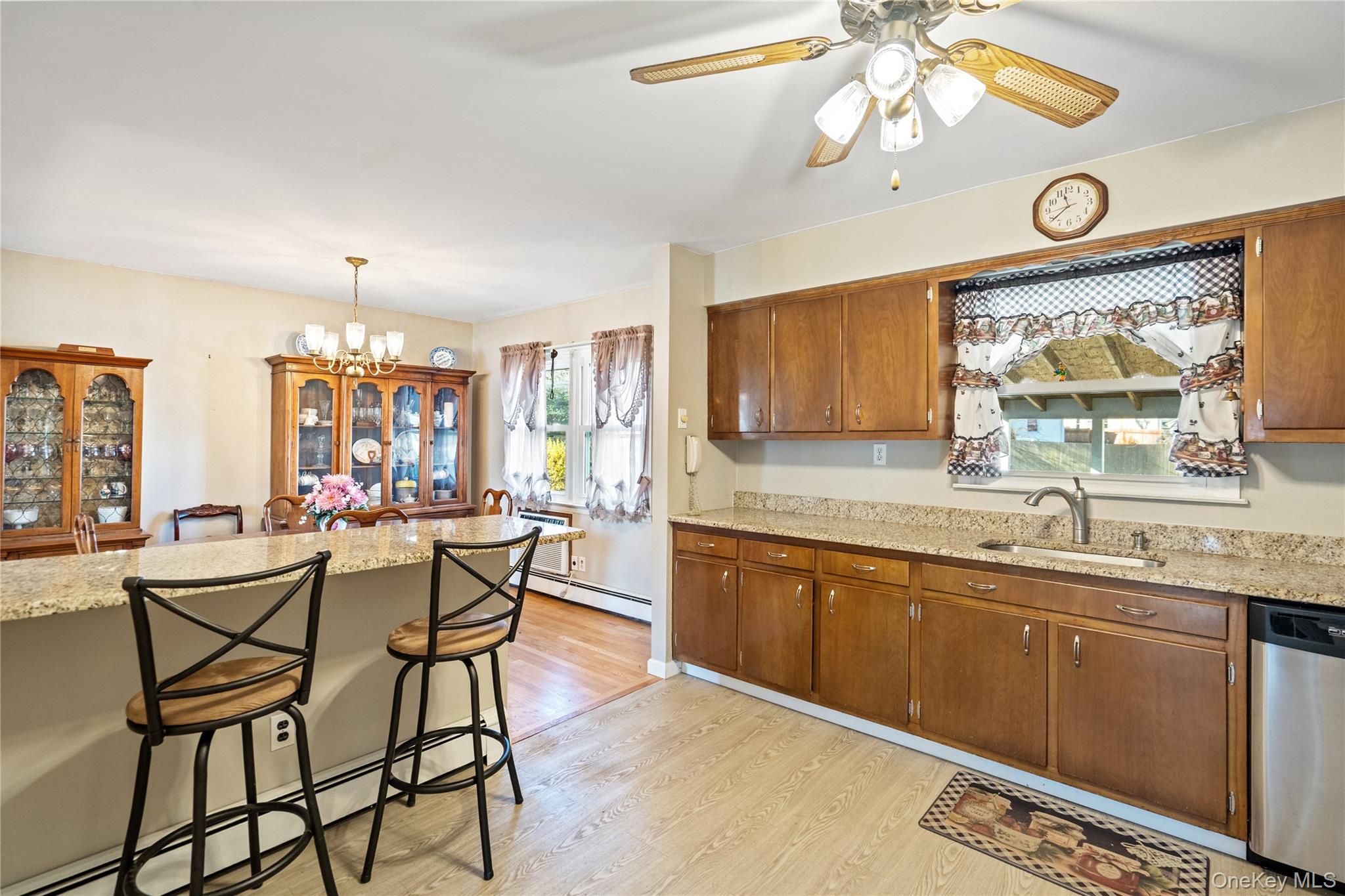 211 Mooney Pond Road Selden, NY 11784 - Photo 15 of 41 a view of a kitchen and a dining table chairs