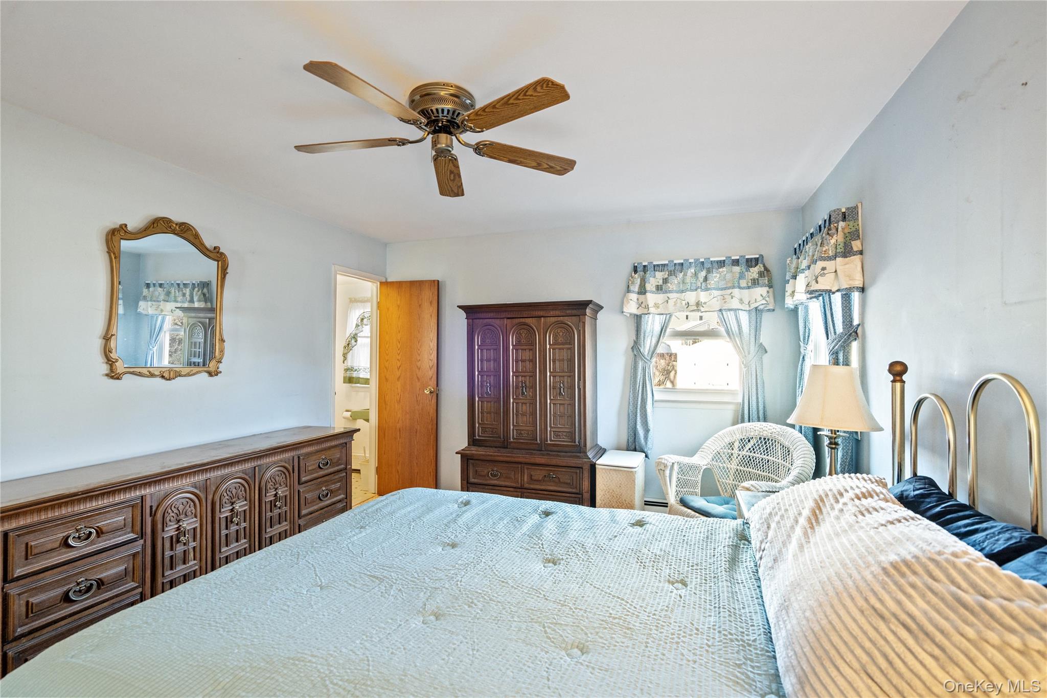 211 Mooney Pond Road Selden, NY 11784 - Photo 18 of 41 a bedroom with a bed and a dresser