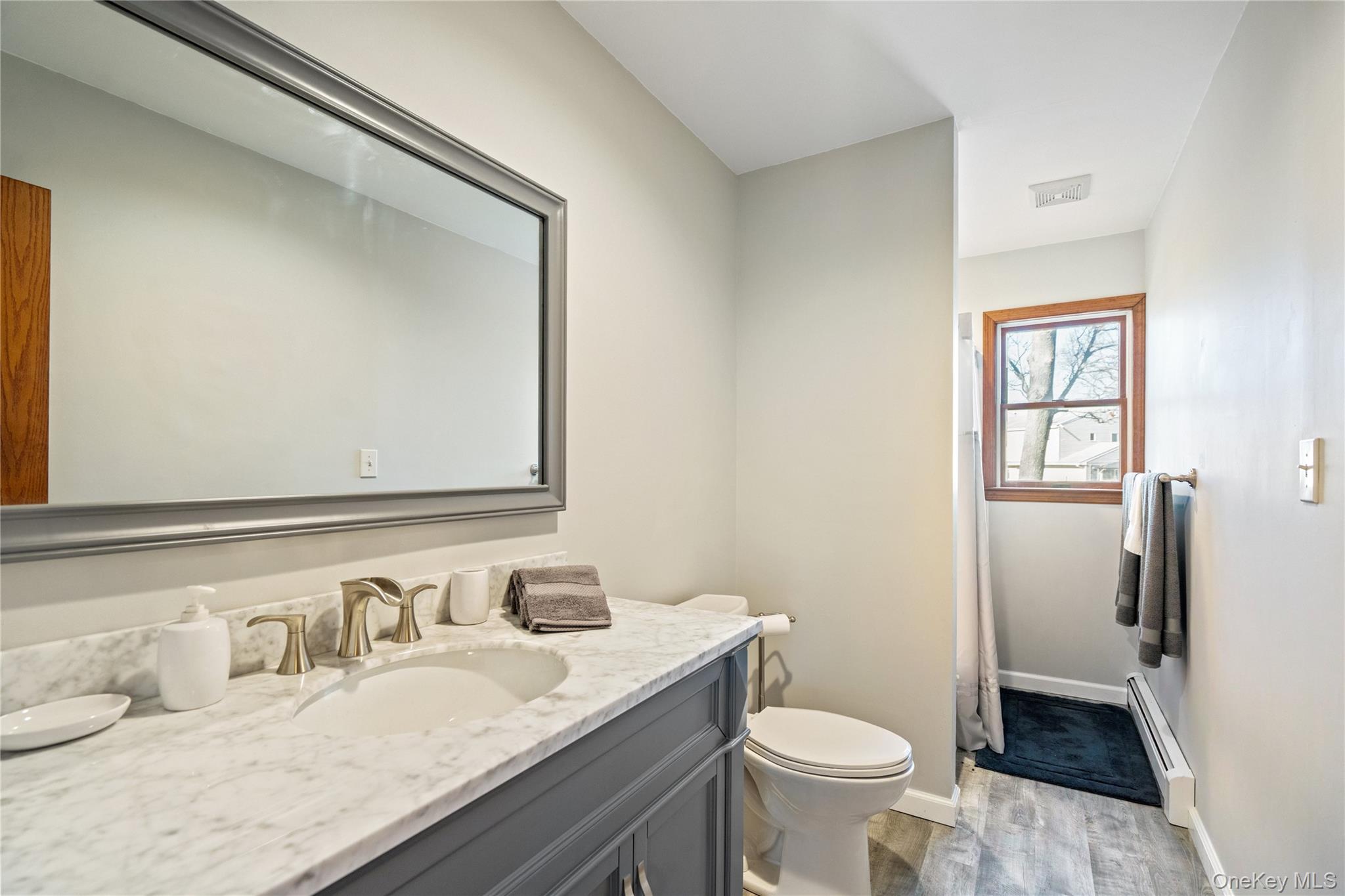 211 Mooney Pond Road Selden, NY 11784 - Photo 27 of 41 a bathroom with a granite countertop toilet sink and mirror