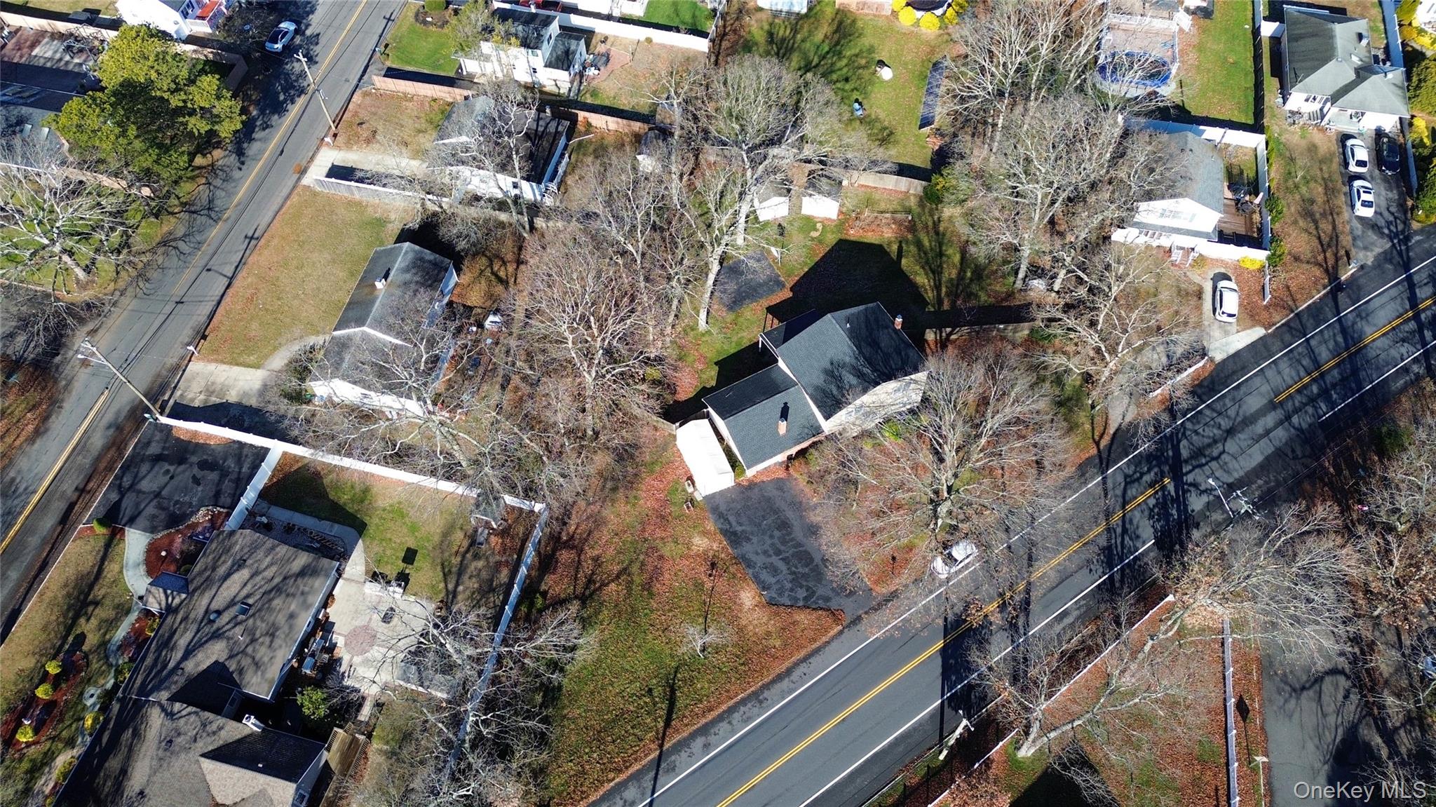211 Mooney Pond Road Selden, NY 11784 - Photo 39 of 41 an aerial view of a residential apartment building with a yard