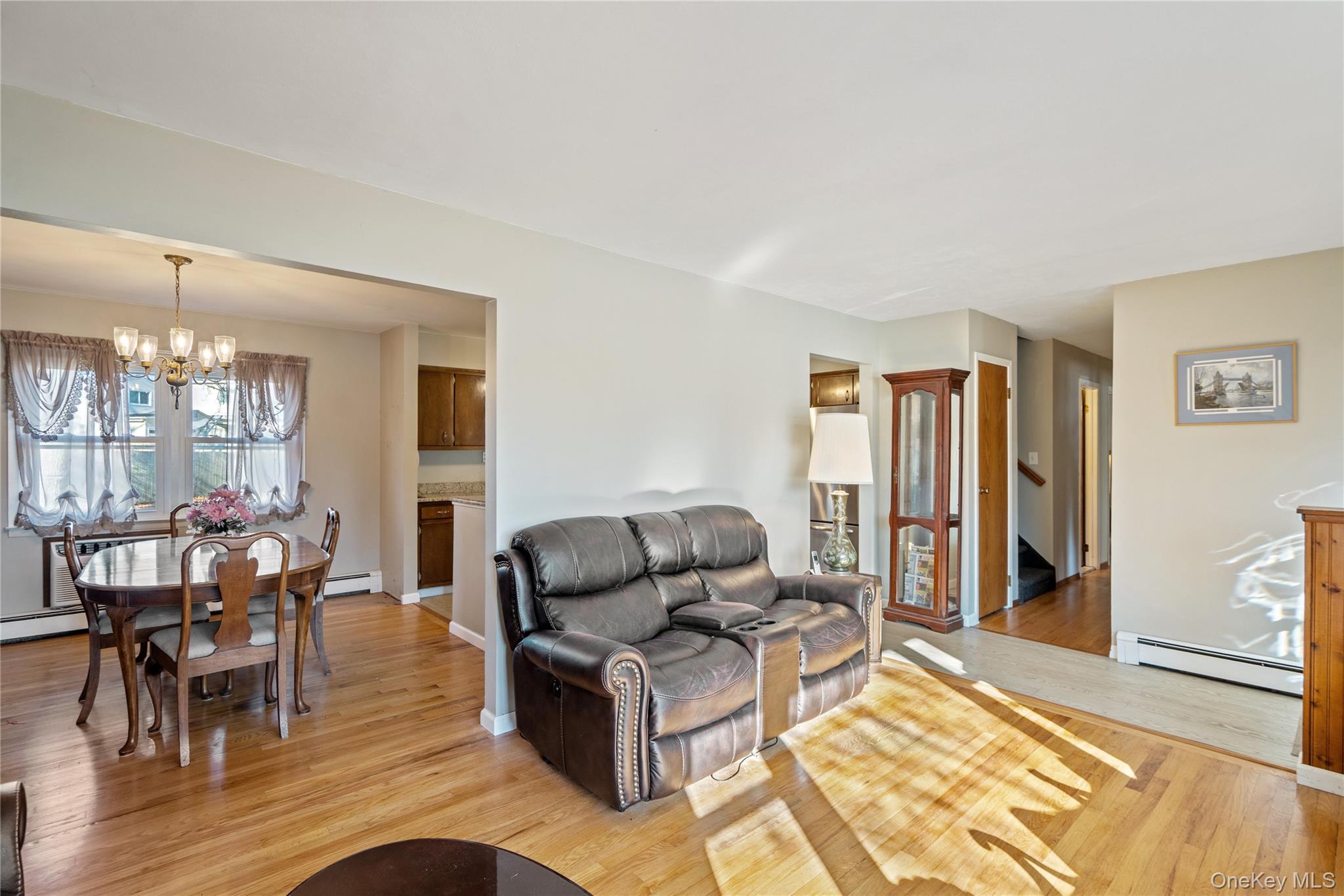 211 Mooney Pond Road Selden, NY 11784 - Photo 5 of 41 a living room with furniture and a dining table