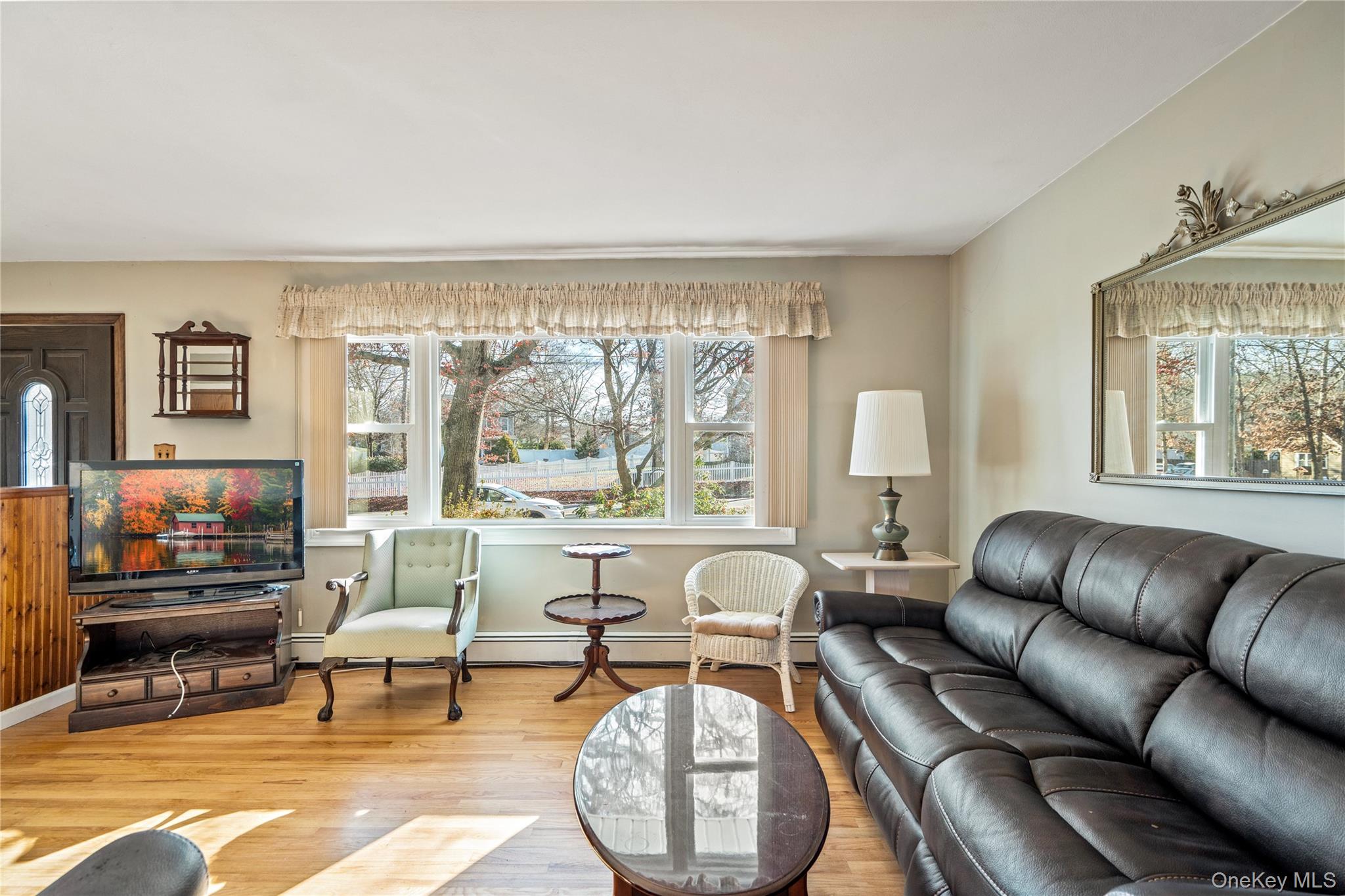 211 Mooney Pond Road Selden, NY 11784 - Photo 7 of 41 a living room with furniture and a large window