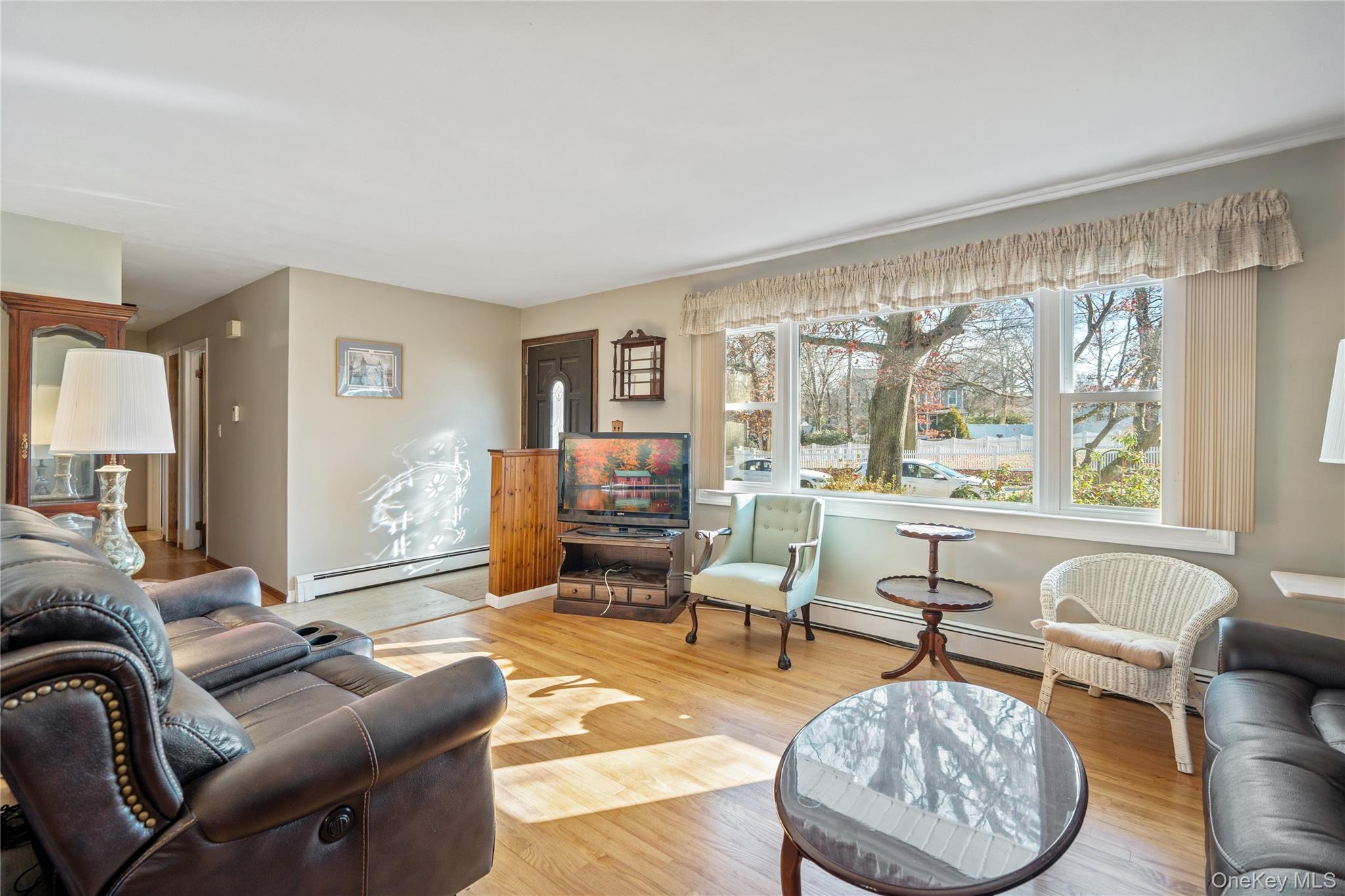 211 Mooney Pond Road Selden, NY 11784 - Photo 8 of 41 a living room with furniture and a large window