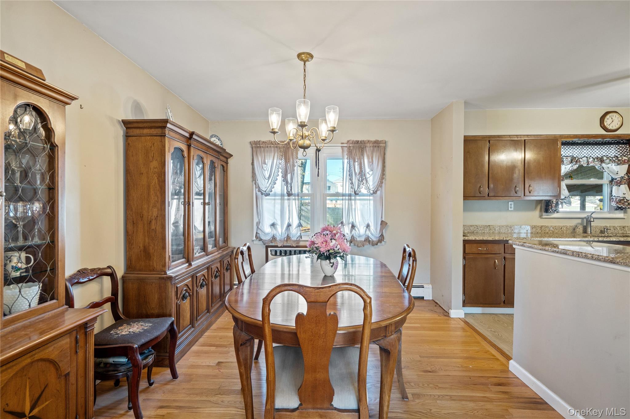 211 Mooney Pond Road Selden, NY 11784 - Photo 9 of 41 a view of a dining room with furniture a chandelier and wooden floor