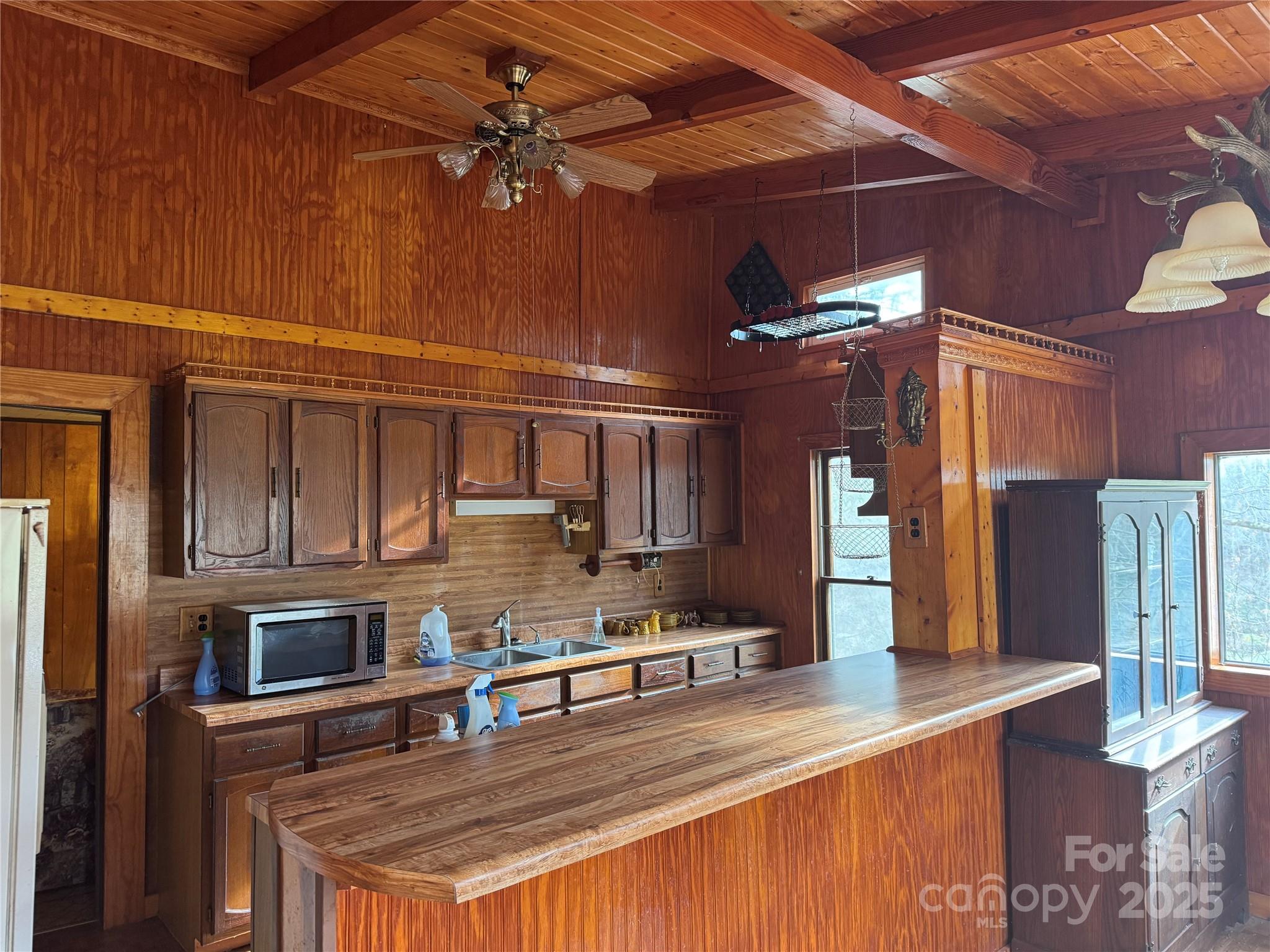 201 Tinsley Road Brevard, NC 28712 - Photo 16 of 23 a kitchen with stainless steel appliances kitchen island granite countertop a refrigerator a stove and a sink with wooden cabinets