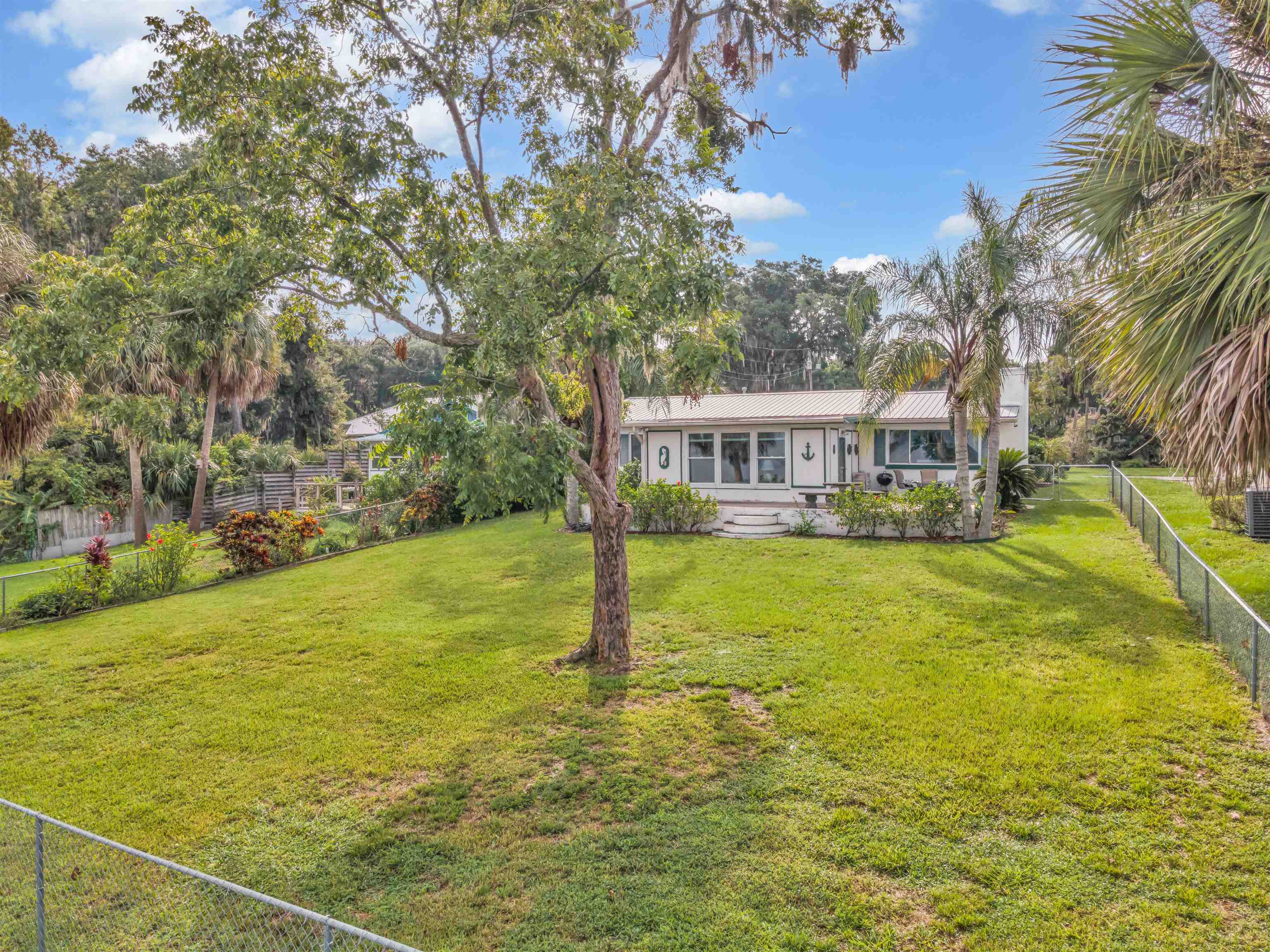 115 Sunset Point Road East Palatka, FL 32131 - Photo 12 of 67 View of front of house riverside with a fenced backyard and a metal roof