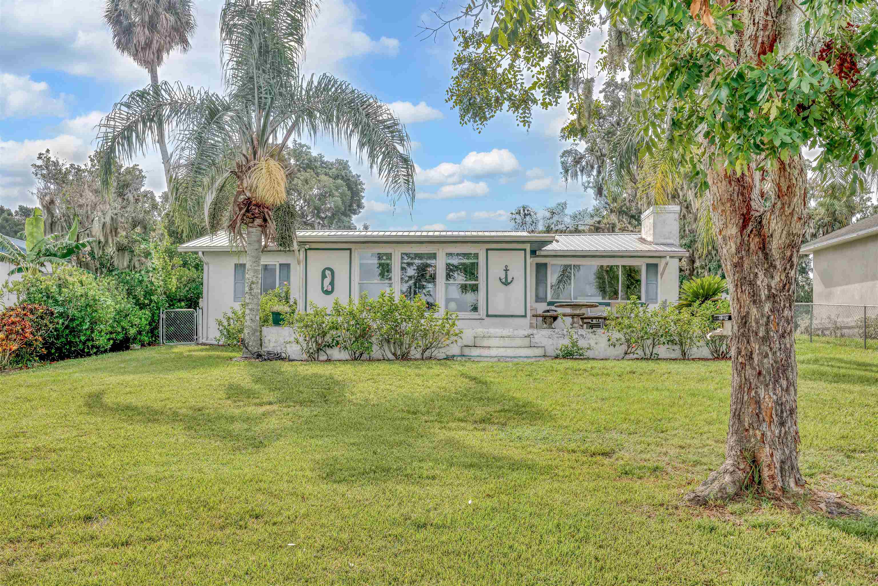 115 Sunset Point Road East Palatka, FL 32131 - Photo 32 of 67 Ranch-style home featuring stucco siding, a metal roof, and a chimney