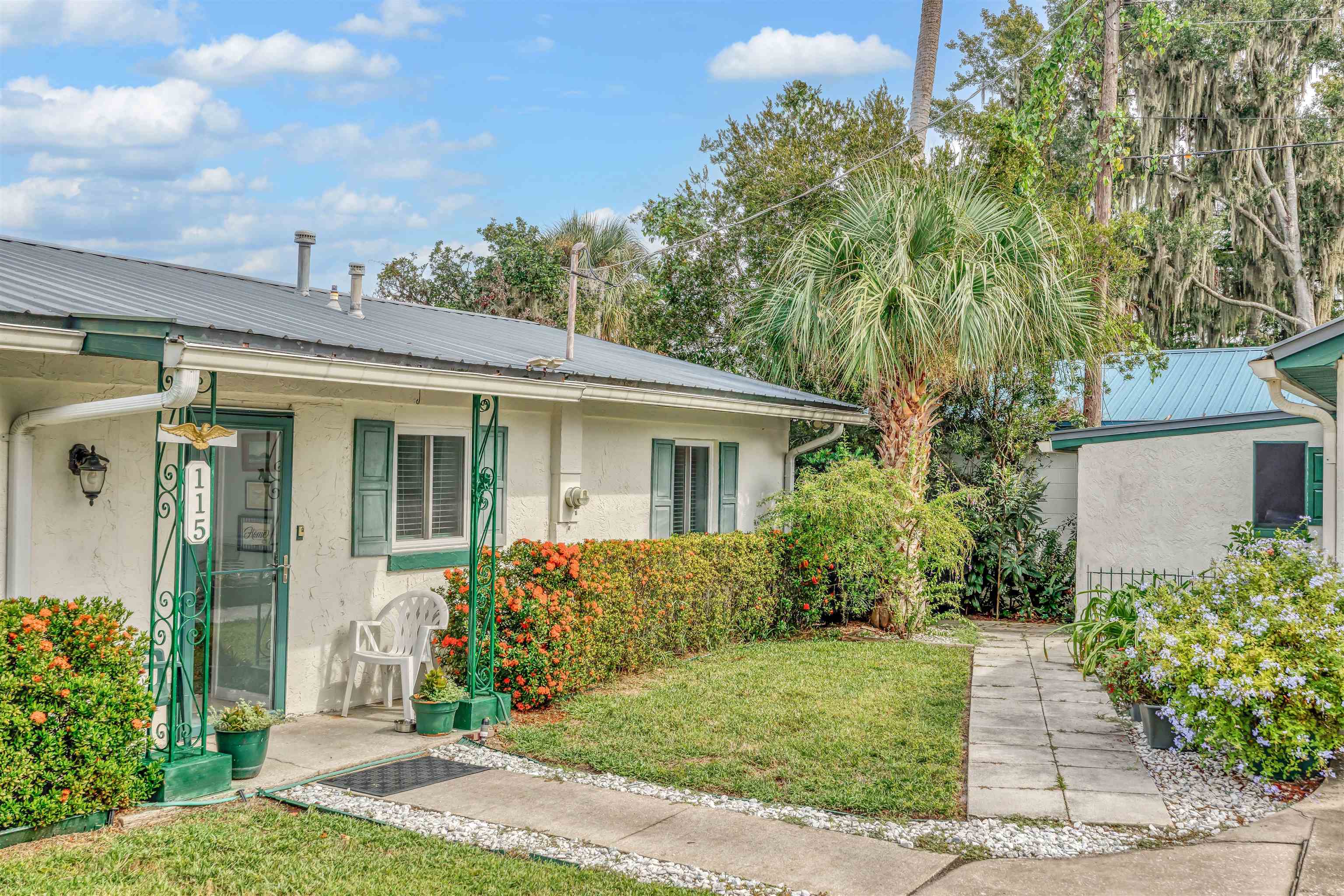 115 Sunset Point Road East Palatka, FL 32131 - Photo 33 of 67 View of front of home with stucco siding, a metal roof, and a front lawn