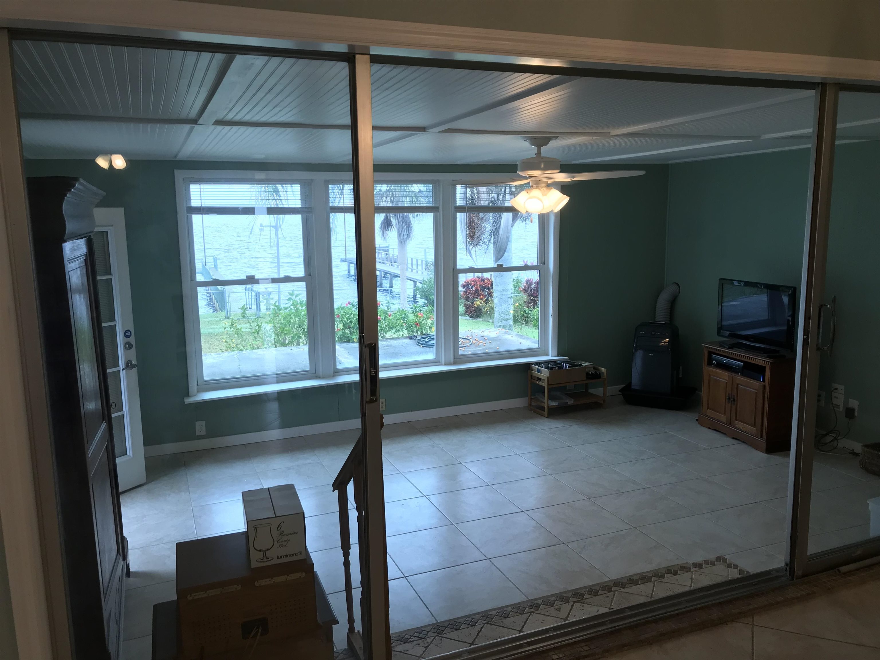 115 Sunset Point Road East Palatka, FL 32131 - Photo 47 of 67 Unfurnished living room with light tile patterned floors and a ceiling fan