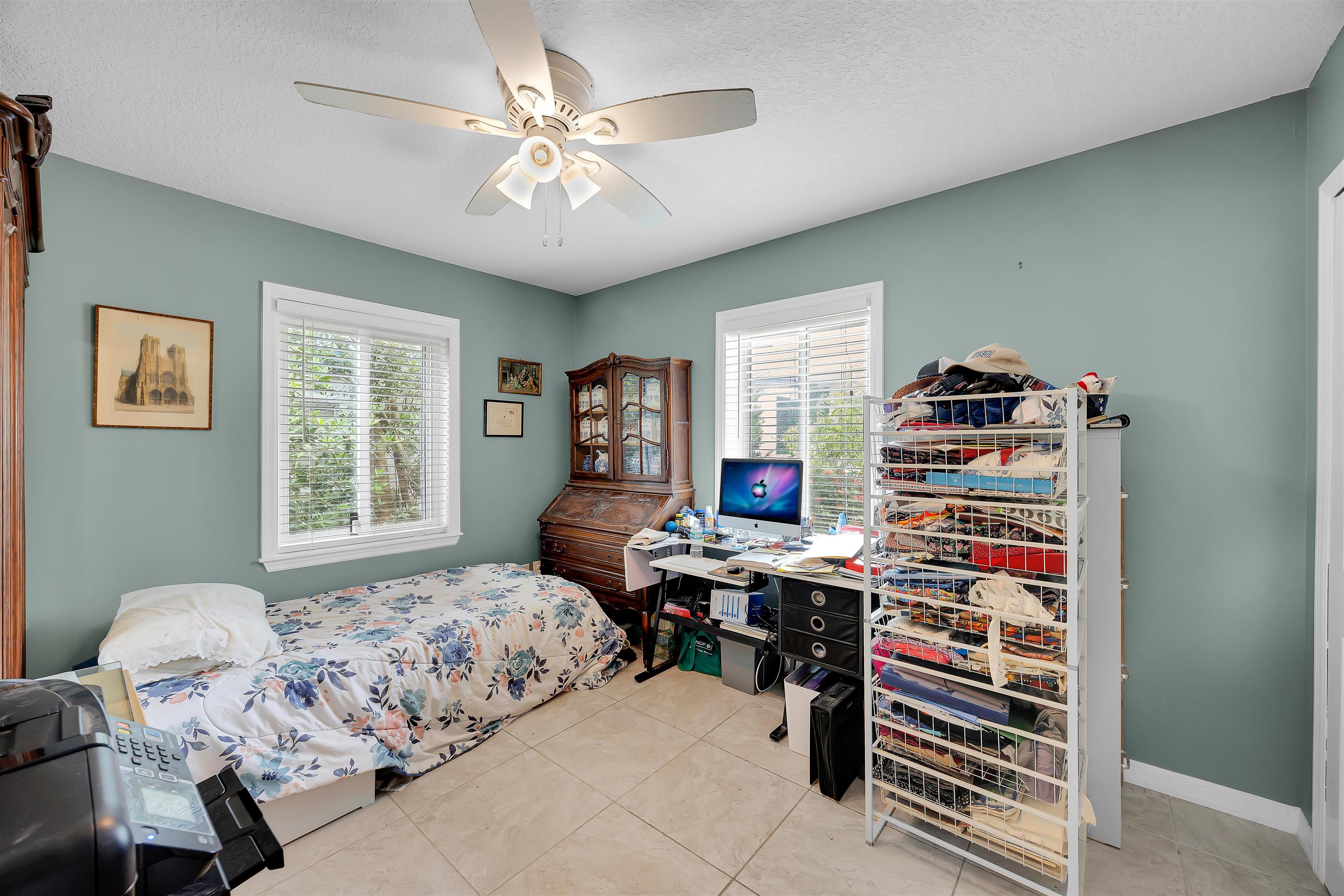 115 Sunset Point Road East Palatka, FL 32131 - Photo 60 of 67 Bedroom featuring light tile patterned floors, multiple windows, ceiling fan, and a textured ceiling