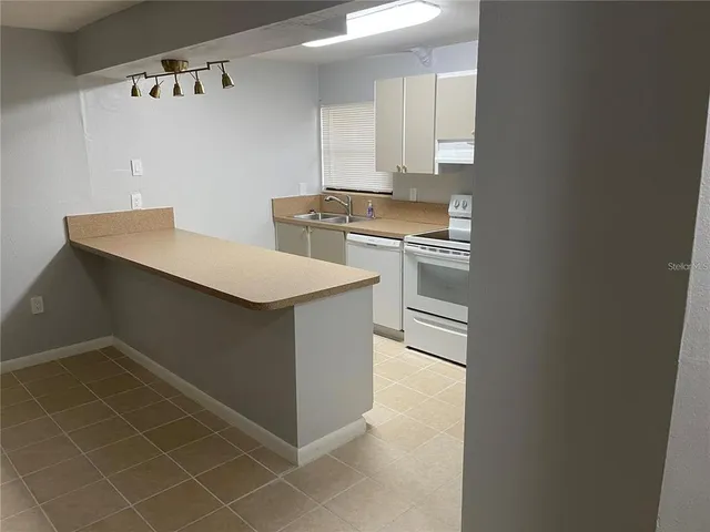 a kitchen with a sink cabinets and appliances