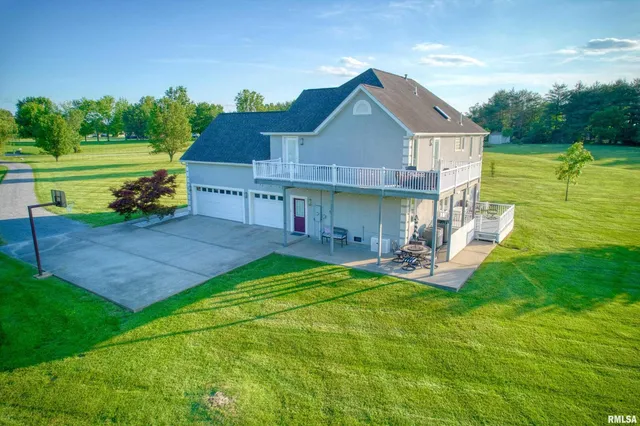 a view of a house with a yard and sitting area