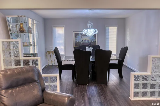 a view of a dining room with furniture wooden floor and chandelier