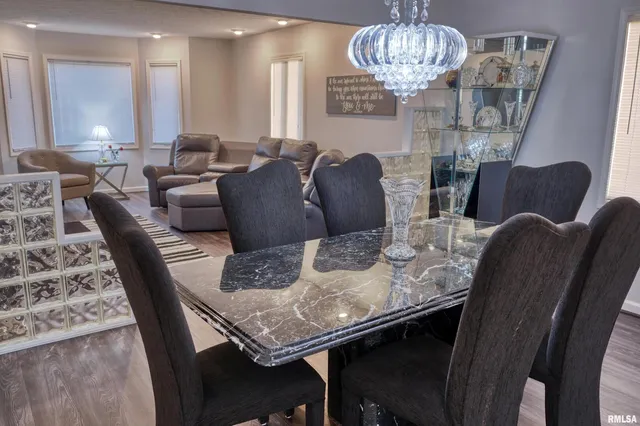 a view of a dining room with furniture wooden floor and chandelier