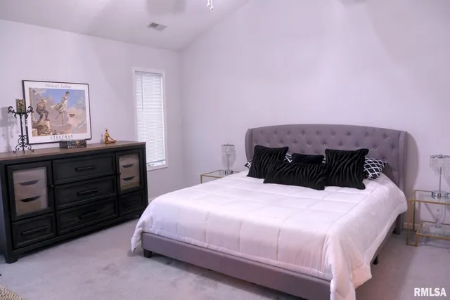 a bedroom with a bed and a dresser
