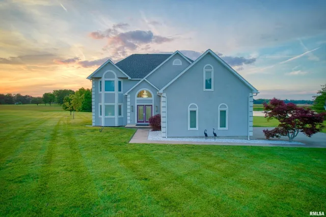 a front view of house with yard and green space