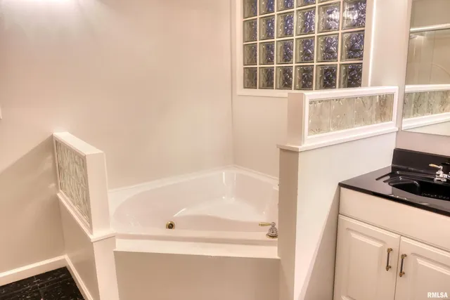 a bathroom with a bathtub and a window