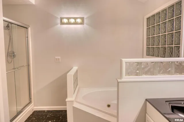 a bathroom with a bathtub and a shower