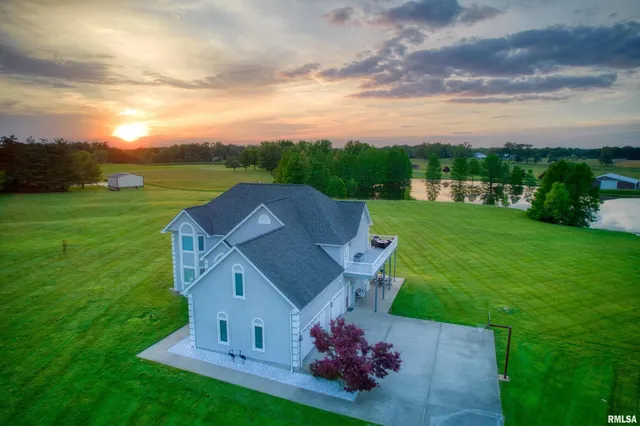 an aerial view of a house with table and chairs
