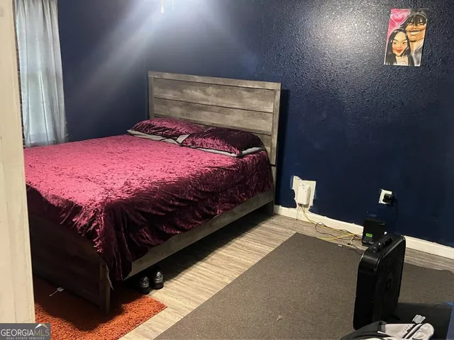 a bed sitting in a bedroom next to a window