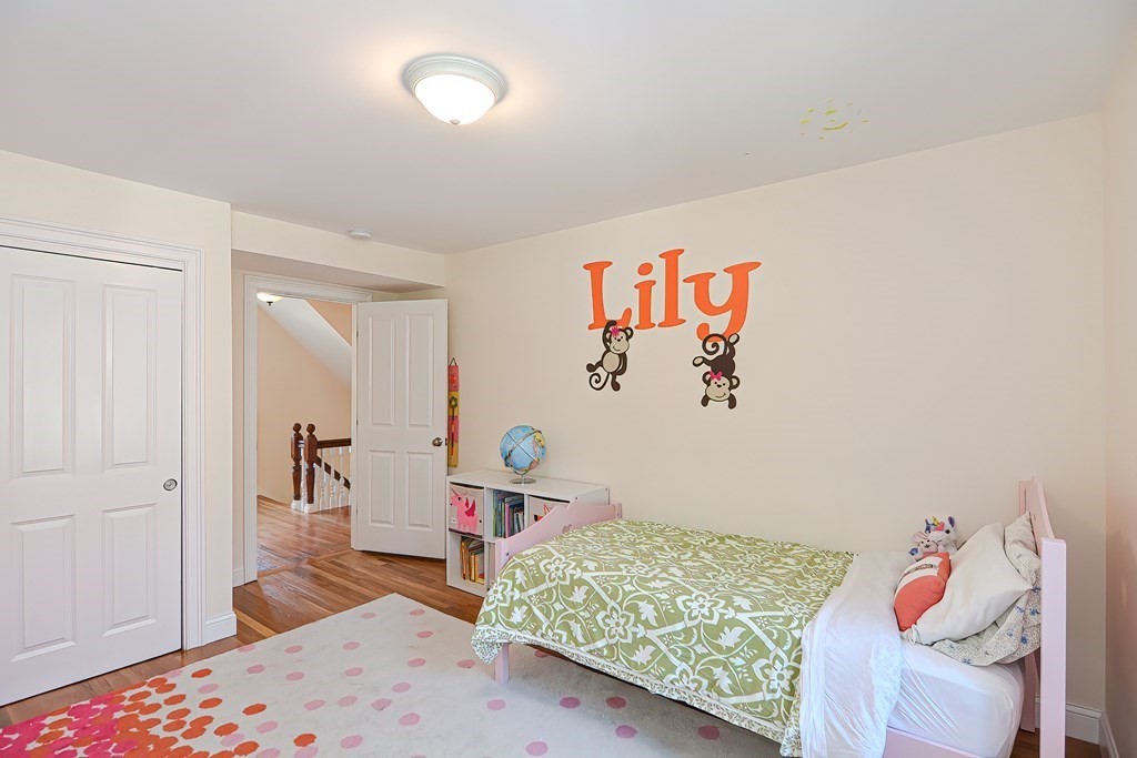 228 Cherry Street Newton, MA 02465 - Photo 24 of 42 a bedroom with a bed and wooden floor