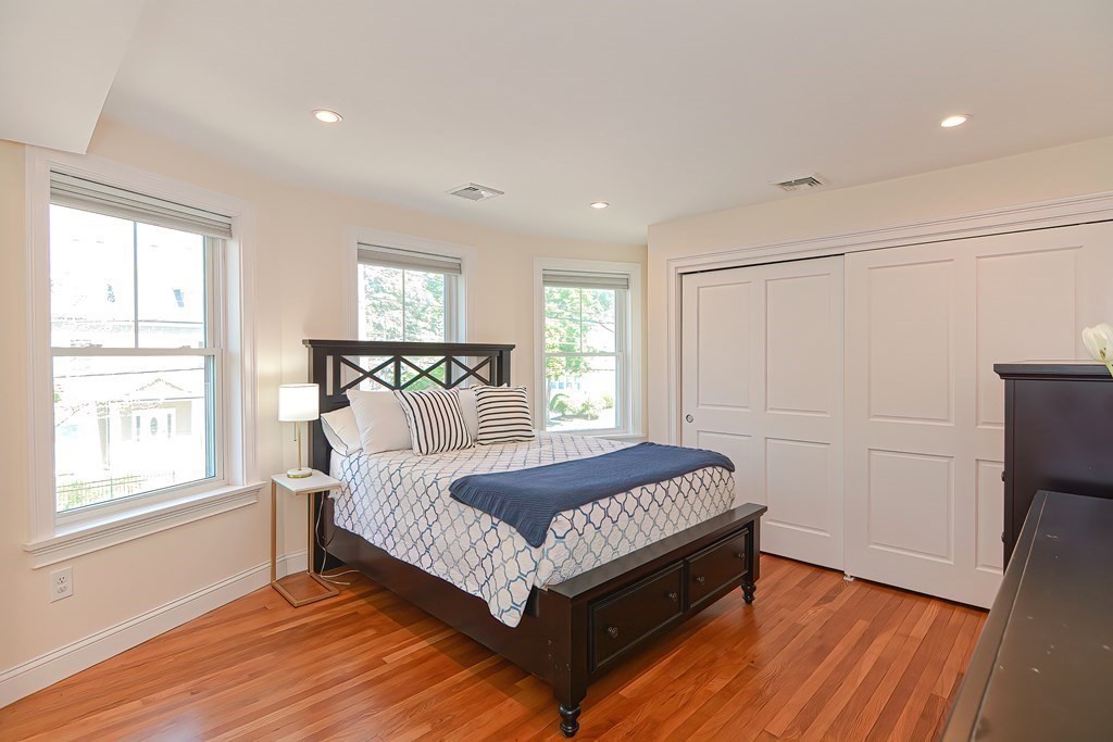 228 Cherry Street Newton, MA 02465 - Photo 29 of 42 a bed sitting in a spacious bedroom next to a window