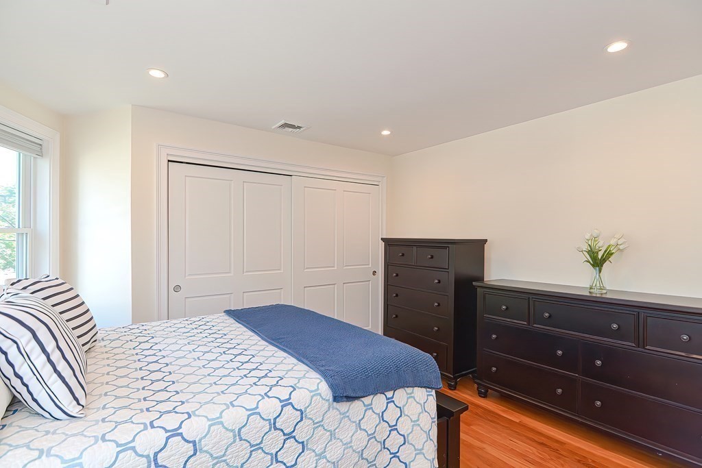228 Cherry Street Newton, MA 02465 - Photo 32 of 42 a bedroom with a bed and a dresser