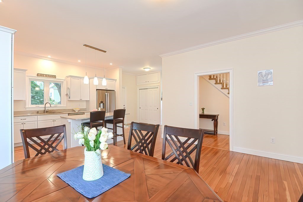 228 Cherry Street Newton, MA 02465 - Photo 8 of 42 a dining room with furniture a rug and a chandelier