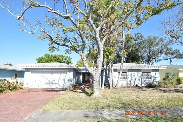 a view of a house with a patio and a yard