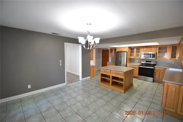 a kitchen with stainless steel appliances a stove top oven and refrigerator