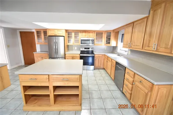 a kitchen with stainless steel appliances a refrigerator and a stove