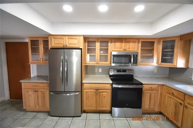 a kitchen with granite countertop a sink and cabinets