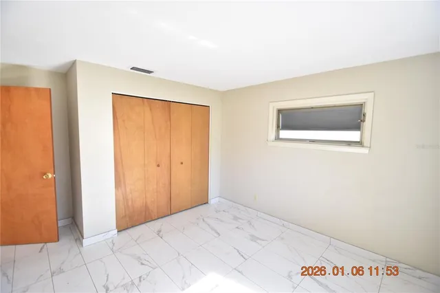 a view of an empty room and a window