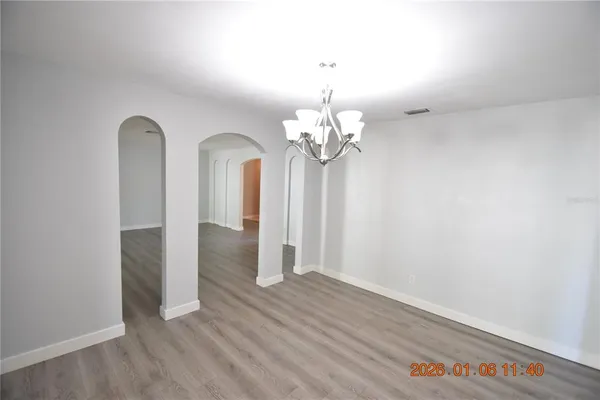 wooden floor in an empty room with a mirror